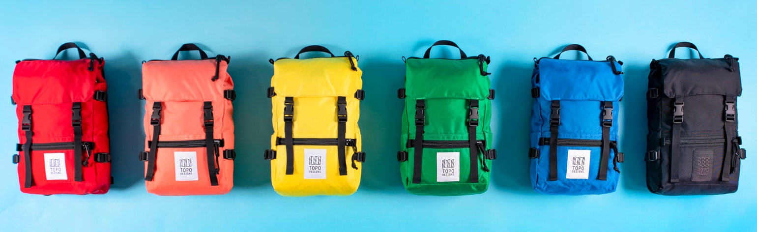 Six Topo Designs Rover Pack Minis in the full color spectrum.